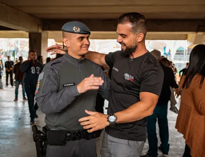 Aluno aprovado abraçando o instrutor Alex Faria